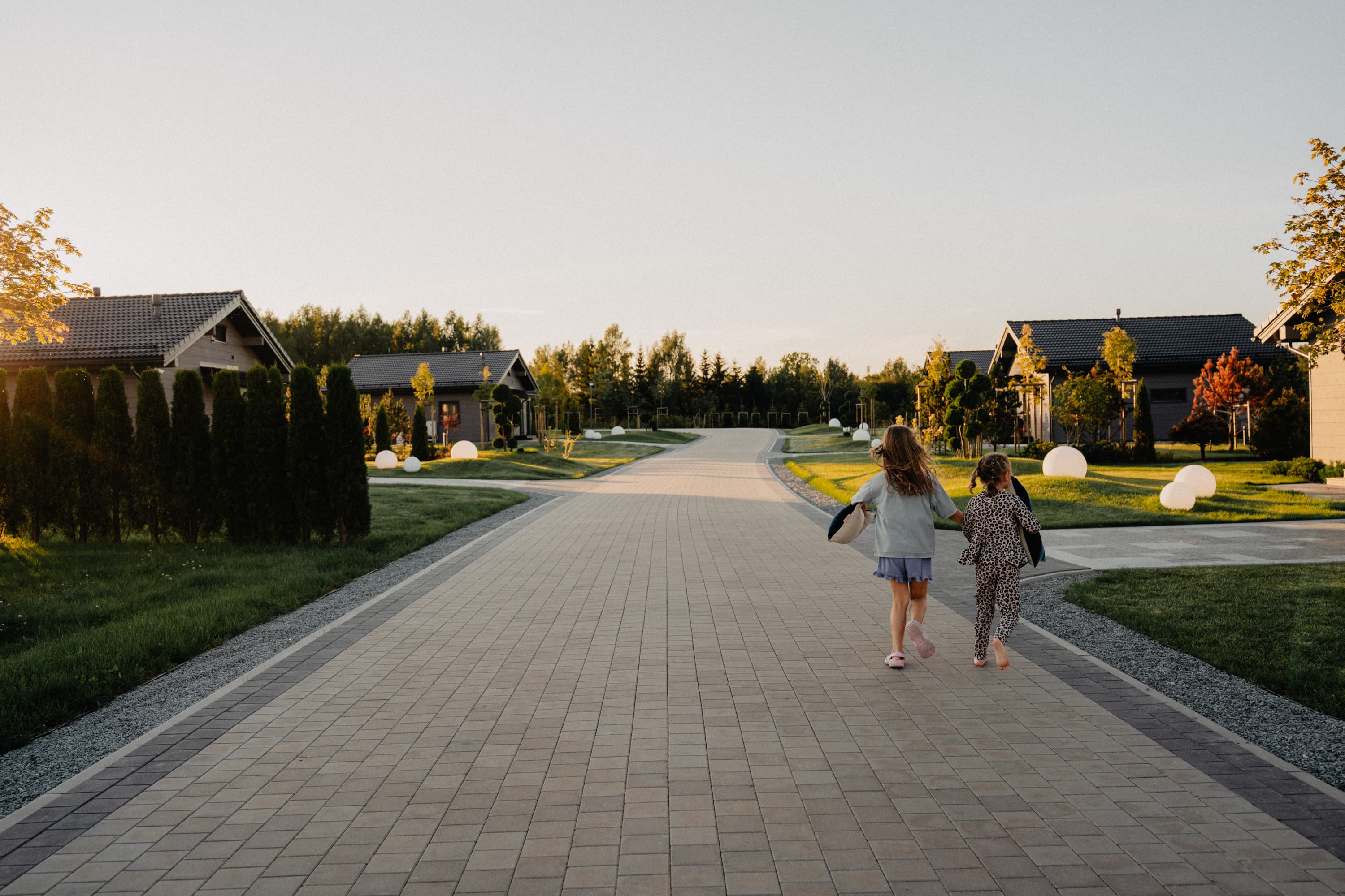 Guests walking near SeoVillage villas at sunset