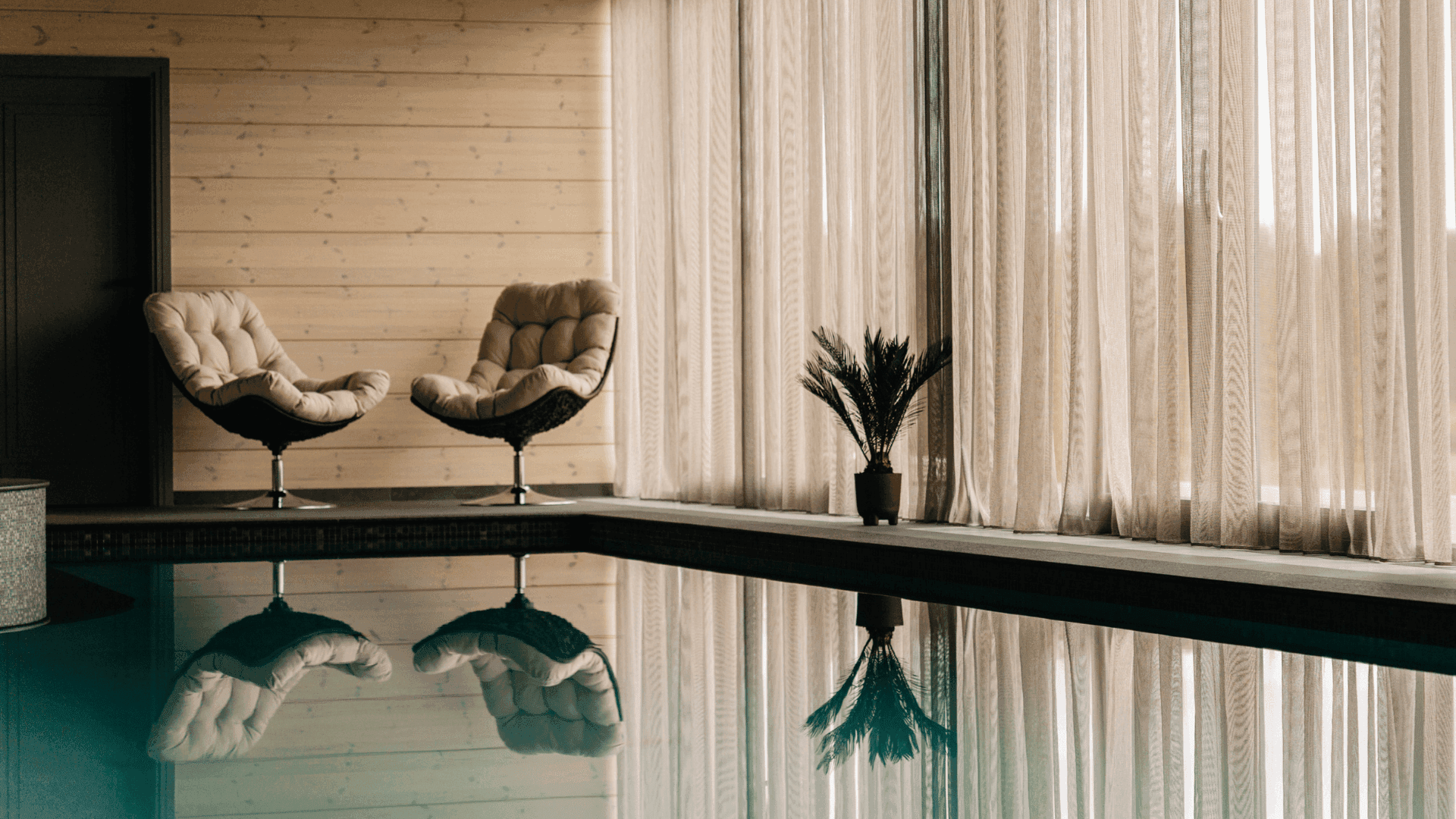 Pool reflection by the lounge chairs